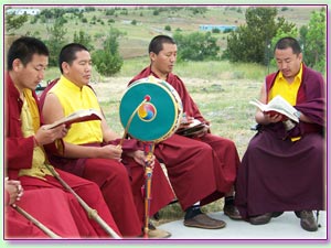 Monks read, chant and play musical instruments